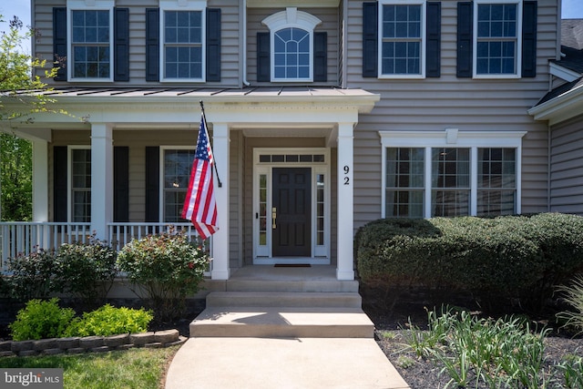 doorway to property featuring covered porch