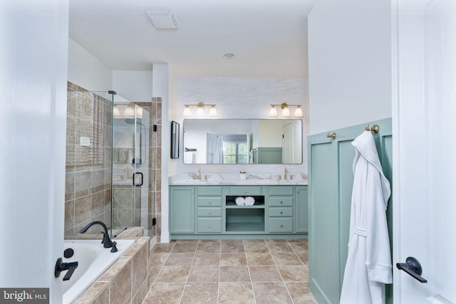 bathroom with a stall shower, double vanity, and a garden tub