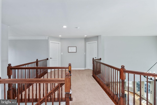 hall with an upstairs landing, recessed lighting, carpet, and baseboards