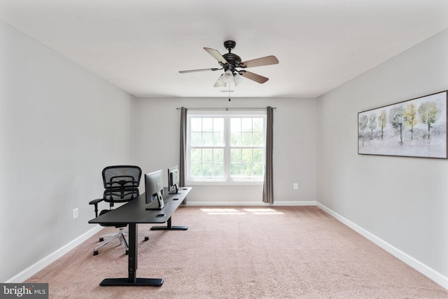 carpeted office featuring baseboards and ceiling fan