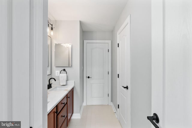 full bathroom with baseboards and double vanity