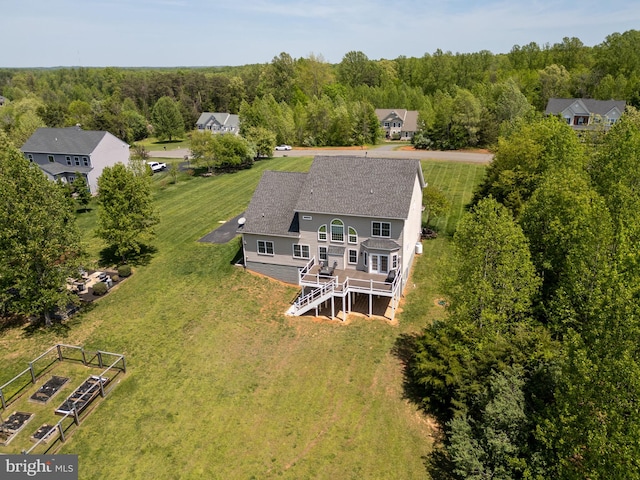 view from above of property with a heavily wooded area