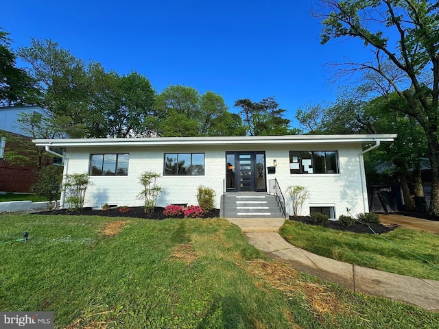 view of front facade featuring brick siding, a front yard, and entry steps