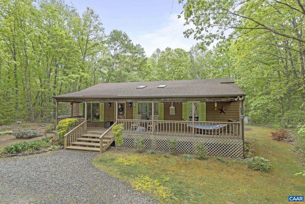 view of front of house with a porch and a shingled roof