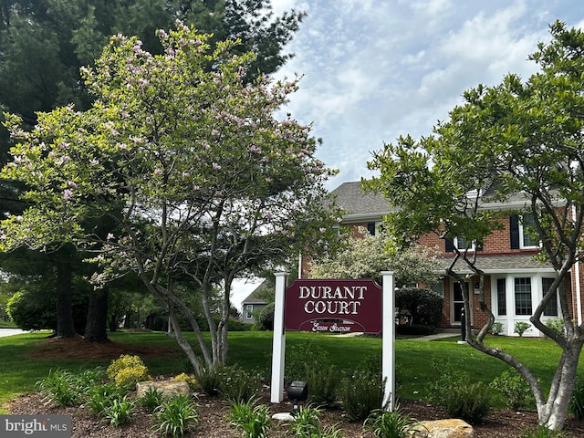 community / neighborhood sign with a yard