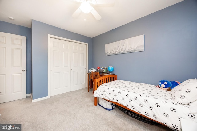 carpeted bedroom featuring a closet and ceiling fan