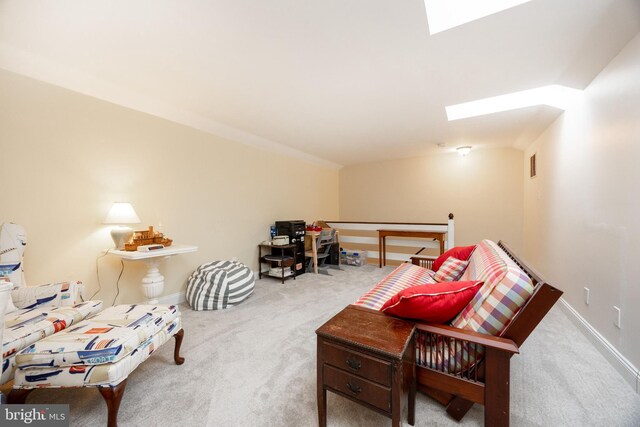 sitting room featuring carpet flooring, visible vents, baseboards, and a skylight