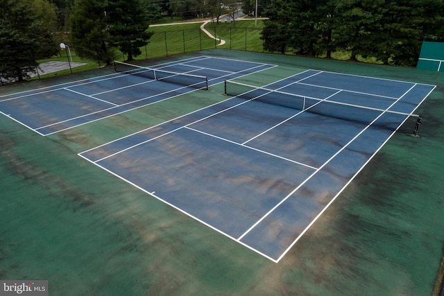 view of tennis court featuring fence