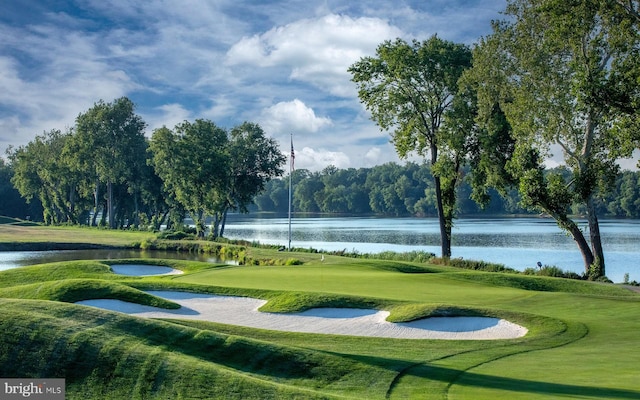view of property's community featuring a lawn and a water view