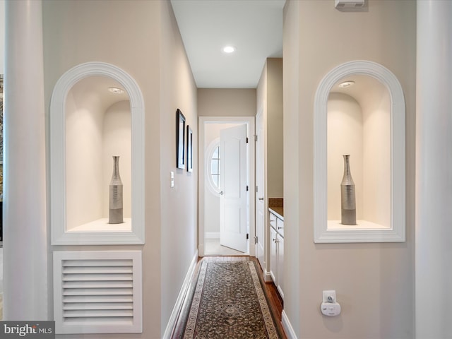 hallway with baseboards and dark wood finished floors