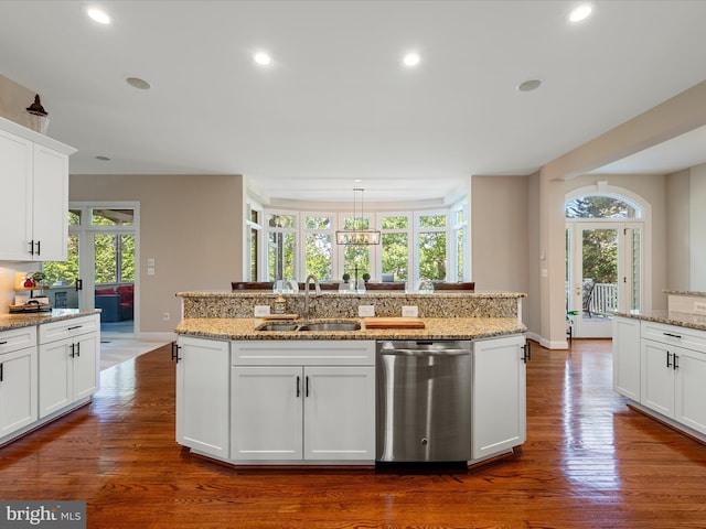 kitchen featuring stainless steel dishwasher, a sink, plenty of natural light, dark wood-type flooring, and recessed lighting