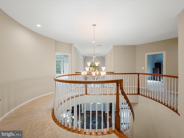 hallway with an upstairs landing, a chandelier, carpet flooring, baseboards, and recessed lighting