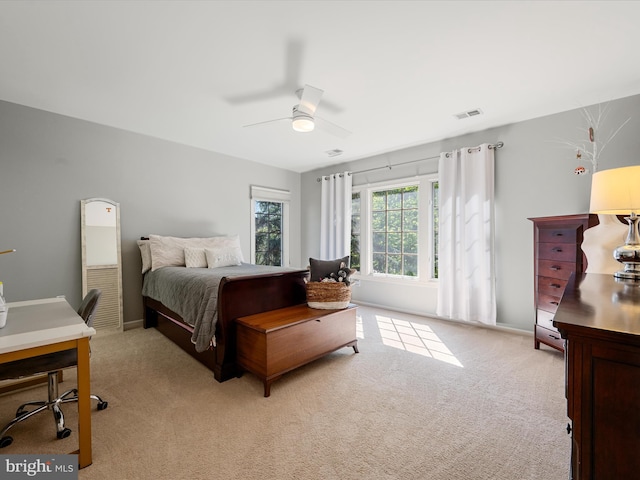bedroom with light colored carpet, a ceiling fan, and baseboards