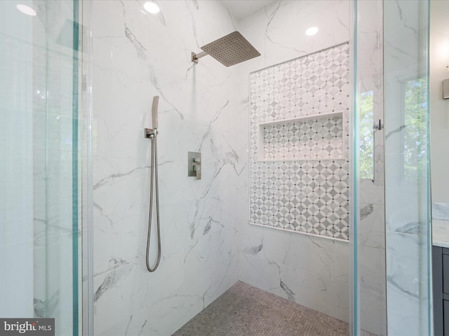 bathroom featuring a marble finish shower