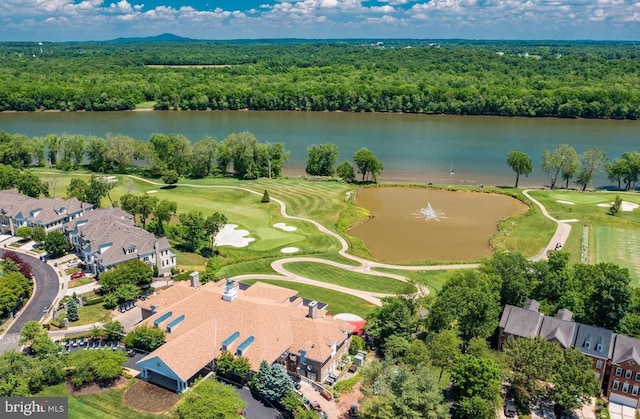 bird's eye view of a forest, a nearby body of water, and a local golf course