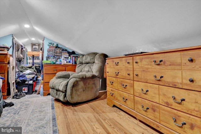 sitting room with lofted ceiling and light wood-type flooring