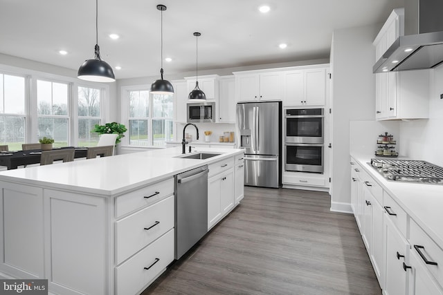 1219 Bear Branch Rd, Laurel, MD 20708 - kitchen with appliances with stainless steel finishes, a sink, light countertops, recessed lighting, and wall chimney exhaust hood