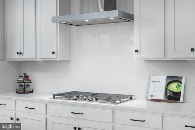 1219 Bear Branch Rd, Laurel, MD 20708 - kitchen with wall chimney range hood, white cabinetry, and light countertops