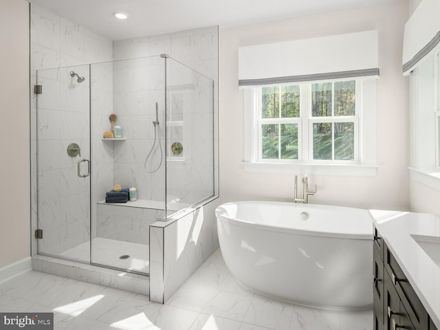 bathroom with recessed lighting, marble finish floor, a soaking tub, and a shower stall