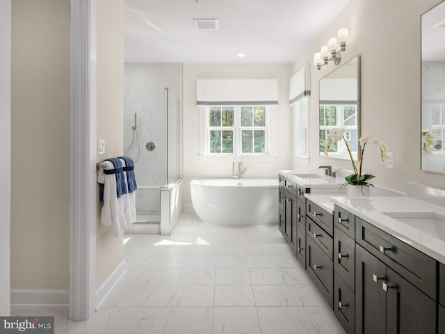 bathroom with double vanity, visible vents, a freestanding tub, a shower stall, and marble finish floor