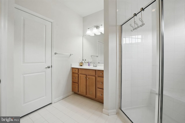 bathroom with tile patterned flooring, baseboards, a stall shower, and vanity