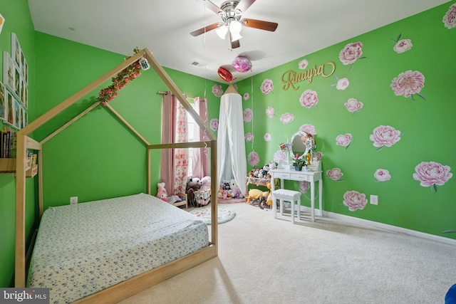 carpeted bedroom with visible vents, baseboards, and ceiling fan