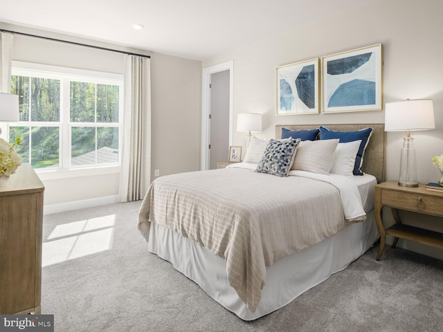 carpeted bedroom with baseboards