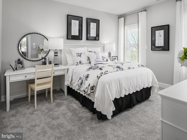 bedroom featuring carpet floors and baseboards