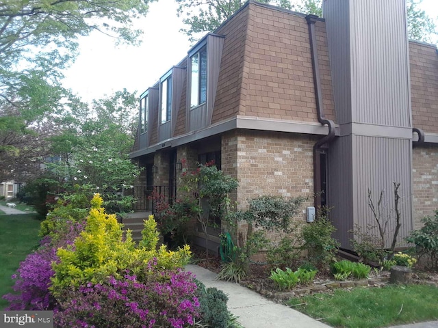 6010 Timber Hollow Ln, Springfield, VA 22152 - view of property exterior with brick siding, mansard roof, and roof with shingles