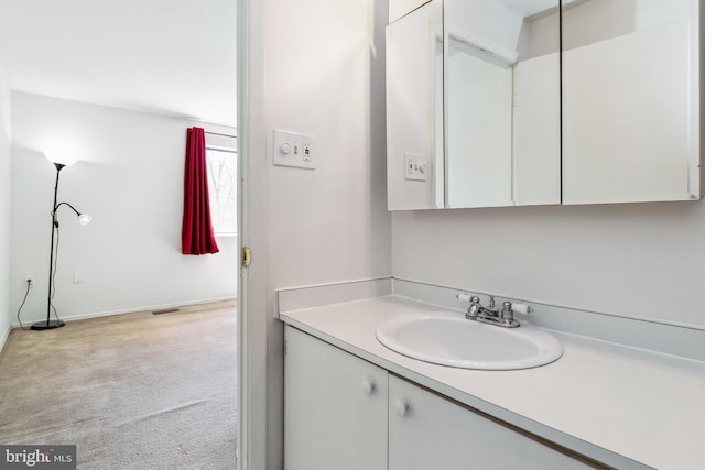 bathroom with vanity and baseboards