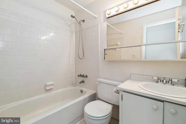 bathroom featuring washtub / shower combination, vanity, and toilet