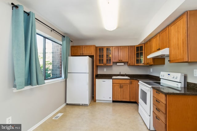 kitchen featuring visible vents, white appliances, under cabinet range hood, brown cabinets, and a sink