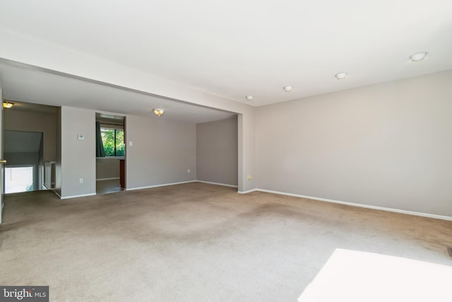 carpeted empty room with baseboards