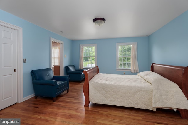 bedroom featuring baseboards and wood finished floors