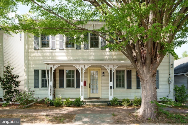 colonial inspired home featuring a porch