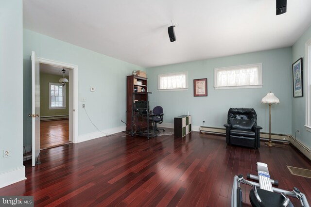 77 N Main St, Cranbury, NJ 08512 - living area with a baseboard radiator, wood finished floors, and healthy amount of natural light