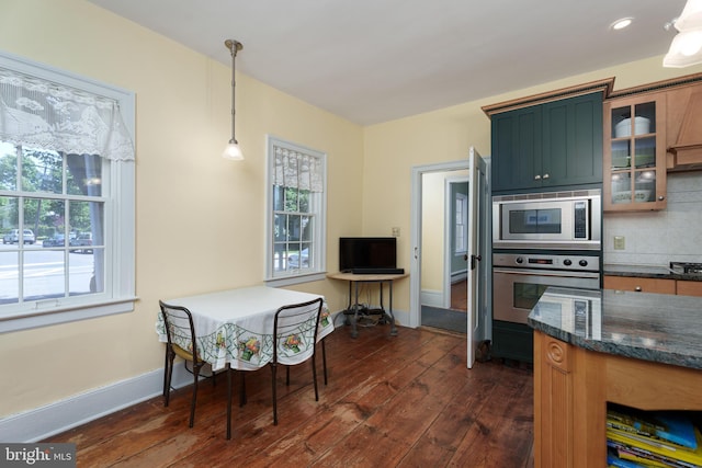 77 N Main St, Cranbury, NJ 08512 - kitchen featuring stainless steel appliances, dark wood-style floors, glass insert cabinets, hanging light fixtures, and backsplash
