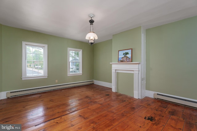 unfurnished living room with wood-type flooring, baseboards, and baseboard heating