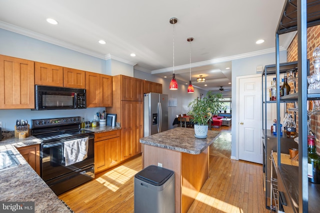 250 S Bouldin St, Baltimore, MD 21224 - kitchen with crown molding, light wood finished floors, a kitchen island, pendant lighting, and black appliances
