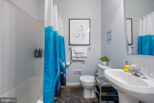 250 S Bouldin St, Baltimore, MD 21224 - bathroom with visible vents, a sink, baseboards, toilet, and stone tile floors