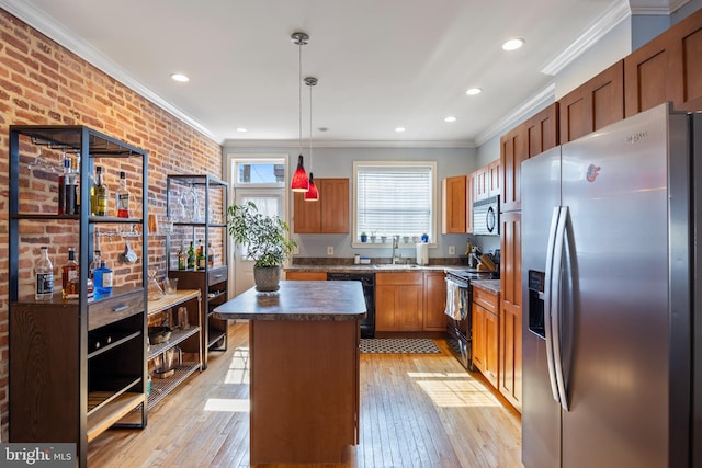 250 S Bouldin St, Baltimore, MD 21224 - kitchen with ornamental molding, a kitchen island, light wood-type flooring, a sink, and black appliances