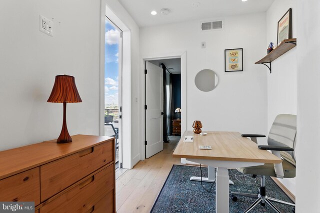 office space with light wood-style floors and recessed lighting
