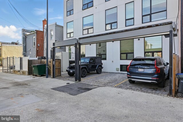 uncovered parking lot featuring fence
