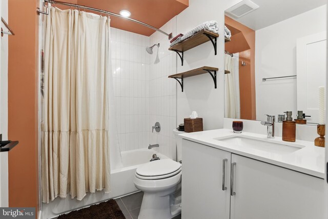 full bathroom featuring shower / bath combo with shower curtain, tile patterned flooring, toilet, and vanity