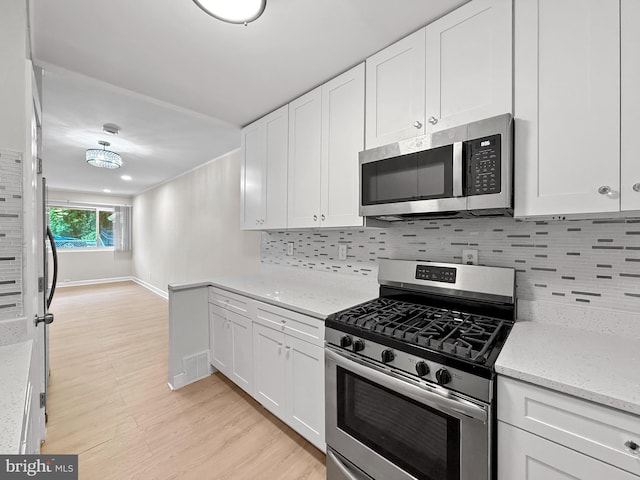 7905 Greenleaf Rd, Landover, MD 20785 - kitchen featuring stainless steel appliances, light wood-style floors, and white cabinets
