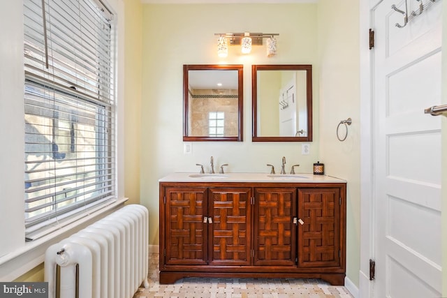 full bath with a sink, radiator, and a wealth of natural light