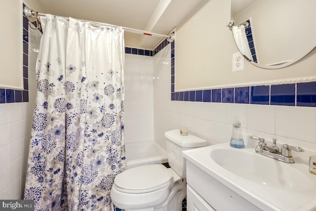 full bathroom featuring toilet, tile walls, shower / bathtub combination with curtain, and vanity