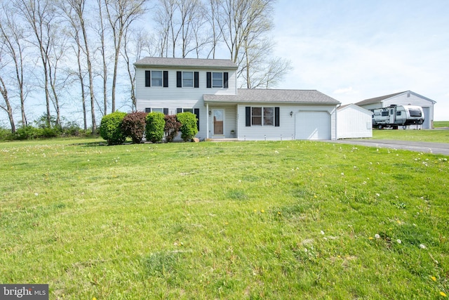 view of front of house with a garage, driveway, and a front lawn