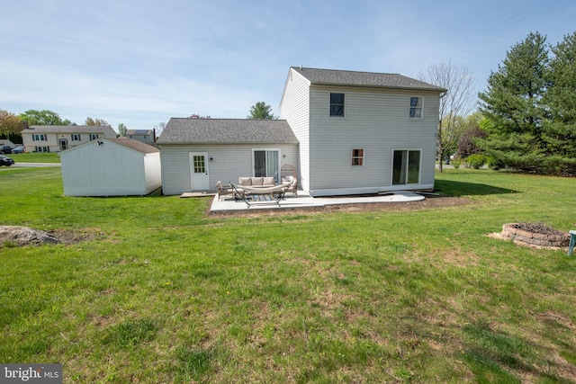 rear view of property with a storage unit, an outdoor structure, a patio area, and a lawn
