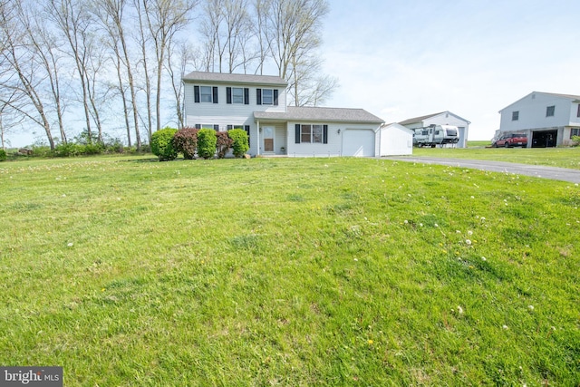 view of front of property with an attached garage, a front lawn, and aphalt driveway